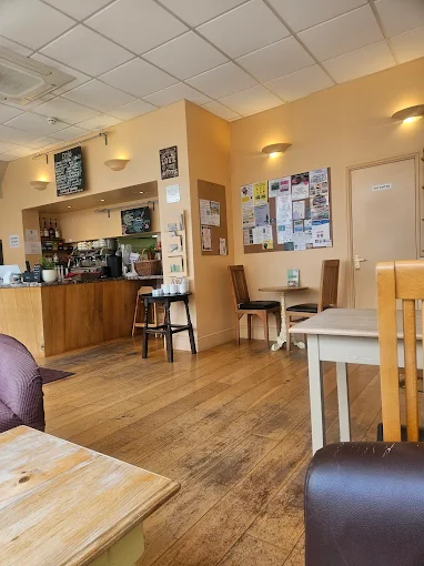 Inside Border Bean - warm wood tables, sage green walls and bright windows